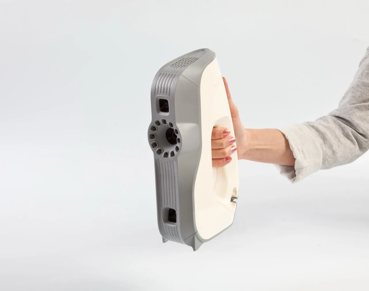Artec Eva structured-light 3D scanner held in one hand