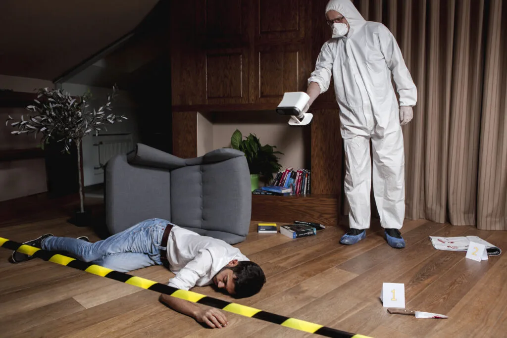Forensic technician in a protective suit scanning evidence markers with Artec Leo